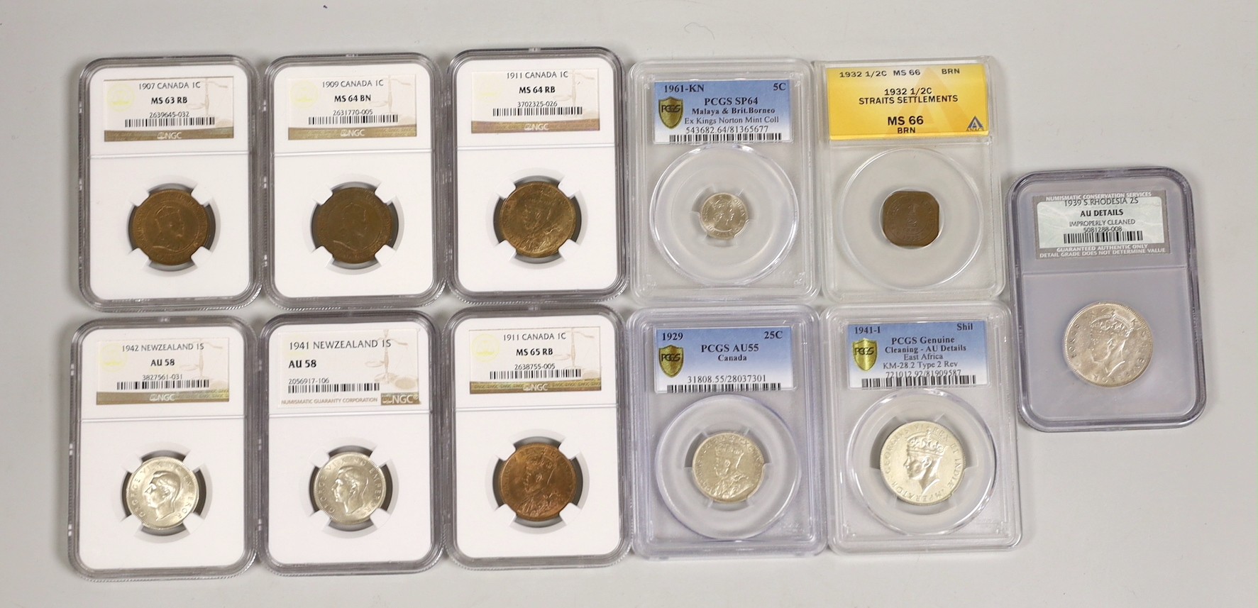 British Empire coins, NGC, PCGS, ANACS slabbed and graded including four Canada 1 cent 1907, 1909, 2 x 1911, 25 cents 1929, two New Zealand 1 shilling 1941 and 1942, Straits Settlements half cent 1932 etc. (11)